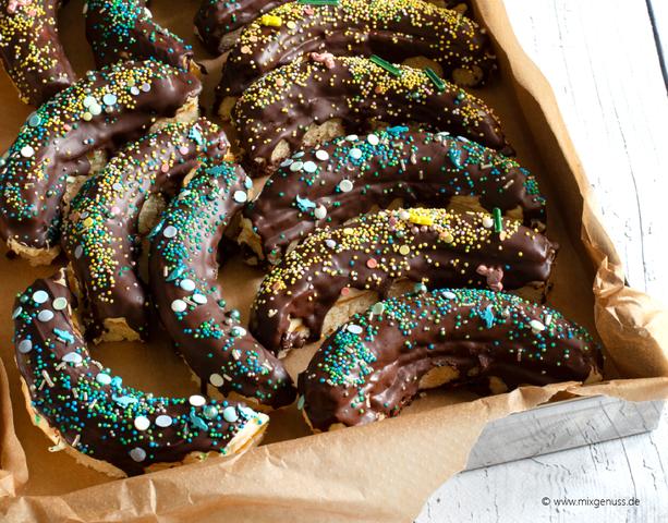 Selbstgemachte Schokobananen mit bunten Streuseln verzieren Selbstgemachte Schokobananen mit bunten Streuseln verzieren